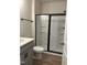 Bathroom featuring a shower with black-framed sliding glass doors and gray vanity at 808 Hillfarm Dr, Wake Forest, NC 27587