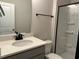 Bathroom showcasing gray vanity, black hardware, and a shower with sliding glass doors at 808 Hillfarm Dr, Wake Forest, NC 27587