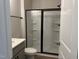 Bathroom featuring a shower with black-framed sliding glass doors and gray vanity at 808 Hillfarm Dr, Wake Forest, NC 27587