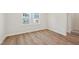 Light filled bedroom with hardwood floors and a view of the neighborhood at 808 Hillfarm Dr, Wake Forest, NC 27587