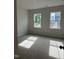 Bright bedroom with two large windows providing natural light and cozy carpeting at 808 Hillfarm Dr, Wake Forest, NC 27587