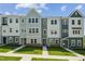 Charming row of townhomes with well-manicured lawn and inviting entrances at 808 Hillfarm Dr, Wake Forest, NC 27587