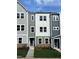 Charming new construction townhome showcases neutral colors and a well-manicured lawn at 808 Hillfarm Dr, Wake Forest, NC 27587