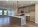 Modern kitchen with an island, stainless steel appliances, and hardwood floors at 808 Hillfarm Dr, Wake Forest, NC 27587
