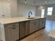 Modern kitchen island features stainless steel dishwasher and modern sink fixtures at 808 Hillfarm Dr, Wake Forest, NC 27587