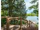 Picturesque lake view with stairs leading to a scenic dock surrounded by lush greenery at 808 Hillfarm Dr, Wake Forest, NC 27587