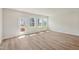 Bright living room with hardwood floors, large windows, and access to a rear deck at 808 Hillfarm Dr, Wake Forest, NC 27587