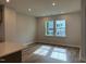 Bright living room with hardwood floors, recessed lighting, and large windows at 808 Hillfarm Dr, Wake Forest, NC 27587