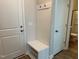 Mudroom featuring a bench seat with storage, hooks, and easy access to the bathroom at 808 Hillfarm Dr, Wake Forest, NC 27587