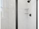 Modern shower with sleek black trim and tiled walls at 808 Hillfarm Dr, Wake Forest, NC 27587