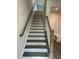 Staircase with white risers, wood treads, and banister leading to the upper level at 808 Hillfarm Dr, Wake Forest, NC 27587