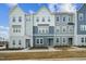 Modern townhome exteriors showcasing neutral color schemes, large windows, and landscaped front yards at 808 Hillfarm Dr, Wake Forest, NC 27587