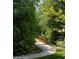 Serene view of a paved walking path bridge surrounded by lush greenery and trees at 808 Hillfarm Dr, Wake Forest, NC 27587