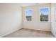 Bright bedroom with two windows providing natural light and neutral carpet at 860 Parc Townes Dr # 70, Wendell, NC 27591