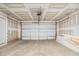 An empty two car garage with a white door and unfinished drywall at 860 Parc Townes Dr # 70, Wendell, NC 27591