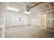 Spacious unfinished garage with concrete floors, electrical panel, and doorway to the interior at 860 Parc Townes Dr # 70, Wendell, NC 27591