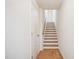 Hallway with wood floors and a staircase featuring white risers and wood treads at 860 Parc Townes Dr # 70, Wendell, NC 27591