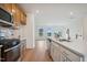 Modern kitchen features stainless steel appliances, white countertops, tile backsplash, and hardwood floors at 860 Parc Townes Dr # 70, Wendell, NC 27591