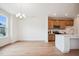 Open-concept living room boasts hardwood floors, chandelier, and view to the kitchen at 860 Parc Townes Dr # 70, Wendell, NC 27591
