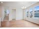 Bright living room with stairs to the left and an abundance of windows providing views of the neighborhood at 860 Parc Townes Dr # 70, Wendell, NC 27591