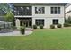 Back exterior view of a multi-story home with a patio, screened-in porch, and landscaping at 1005 Collins Dr, Raleigh, NC 27609