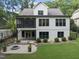 Back exterior view of a multi-story home with a patio and a screened-in porch at 1005 Collins Dr, Raleigh, NC 27609