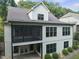 Back exterior view of a multi-story home with a screened-in porch and a patio at 1005 Collins Dr, Raleigh, NC 27609