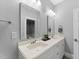 Bathroom featuring double sinks, framed mirrors, and modern lighting at 1005 Collins Dr, Raleigh, NC 27609