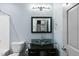 Bathroom with a modern vanity and glass sink, and a toilet with a shower and curtain at 1005 Collins Dr, Raleigh, NC 27609