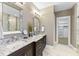 Bathroom featuring double sinks with granite countertops and a walk-in closet at 1005 Collins Dr, Raleigh, NC 27609