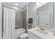 Bathroom with shower and tub combo, ceramic tile, and a vanity with framed mirror at 1005 Collins Dr, Raleigh, NC 27609