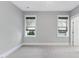 Spacious, well-lit bedroom with plush carpeting and windows with woven shades at 1005 Collins Dr, Raleigh, NC 27609