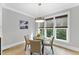 Bright breakfast nook with a round table and large windows overlooking the backyard at 1005 Collins Dr, Raleigh, NC 27609
