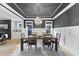 Dining room with a dark ceiling, wainscotting, modern chandelier, wood floors, and natural light at 1005 Collins Dr, Raleigh, NC 27609