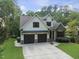 Beautiful two-story home with a stone facade and a spacious two-car garage at 1005 Collins Dr, Raleigh, NC 27609