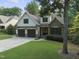 Charming two-story home with a manicured lawn, stone accents, and a two-car garage at 1005 Collins Dr, Raleigh, NC 27609