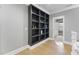 Hallway featuring a built-in bookcase with an open doorway to the next room at 1005 Collins Dr, Raleigh, NC 27609