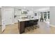 Modern kitchen with white cabinets, stainless steel appliances, a kitchen island, and dining area at 1005 Collins Dr, Raleigh, NC 27609
