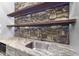 Stylish kitchen with stone backsplash, custom shelving, and modern stainless steel sink at 1005 Collins Dr, Raleigh, NC 27609