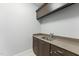 Functional laundry area with sink, granite countertops, and convenient storage at 1005 Collins Dr, Raleigh, NC 27609