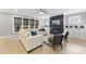 Inviting living room with a fireplace, built-in cabinets, large windows and hardwood floors at 1005 Collins Dr, Raleigh, NC 27609