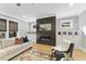 Stylish living room featuring a sleek fireplace, built-in storage, and comfortable seating at 1005 Collins Dr, Raleigh, NC 27609