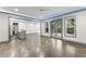 Open concept living room featuring a wet bar and French doors leading to the outdoors at 1005 Collins Dr, Raleigh, NC 27609