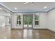 Bright living room with ceiling fan and French doors leading to an outdoor area at 1005 Collins Dr, Raleigh, NC 27609
