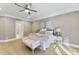 Spacious bedroom with hardwood floors and a ceiling fan, with a glimpse into the Primary bath at 1005 Collins Dr, Raleigh, NC 27609