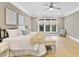 Sunlit bedroom with hardwood floors and a large window with wooded views at 1005 Collins Dr, Raleigh, NC 27609