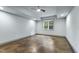 An empty room featuring large window with a view, ceiling fan and concrete floors at 1005 Collins Dr, Raleigh, NC 27609