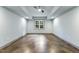 An empty room featuring large window with a view, ceiling fan and concrete floors at 1005 Collins Dr, Raleigh, NC 27609
