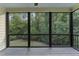 Inviting screened-in porch with natural light and scenic views of the lush greenery at 1005 Collins Dr, Raleigh, NC 27609