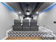 Home theater featuring tiered seating, projector, and starry ceiling for an immersive experience at 1005 Collins Dr, Raleigh, NC 27609